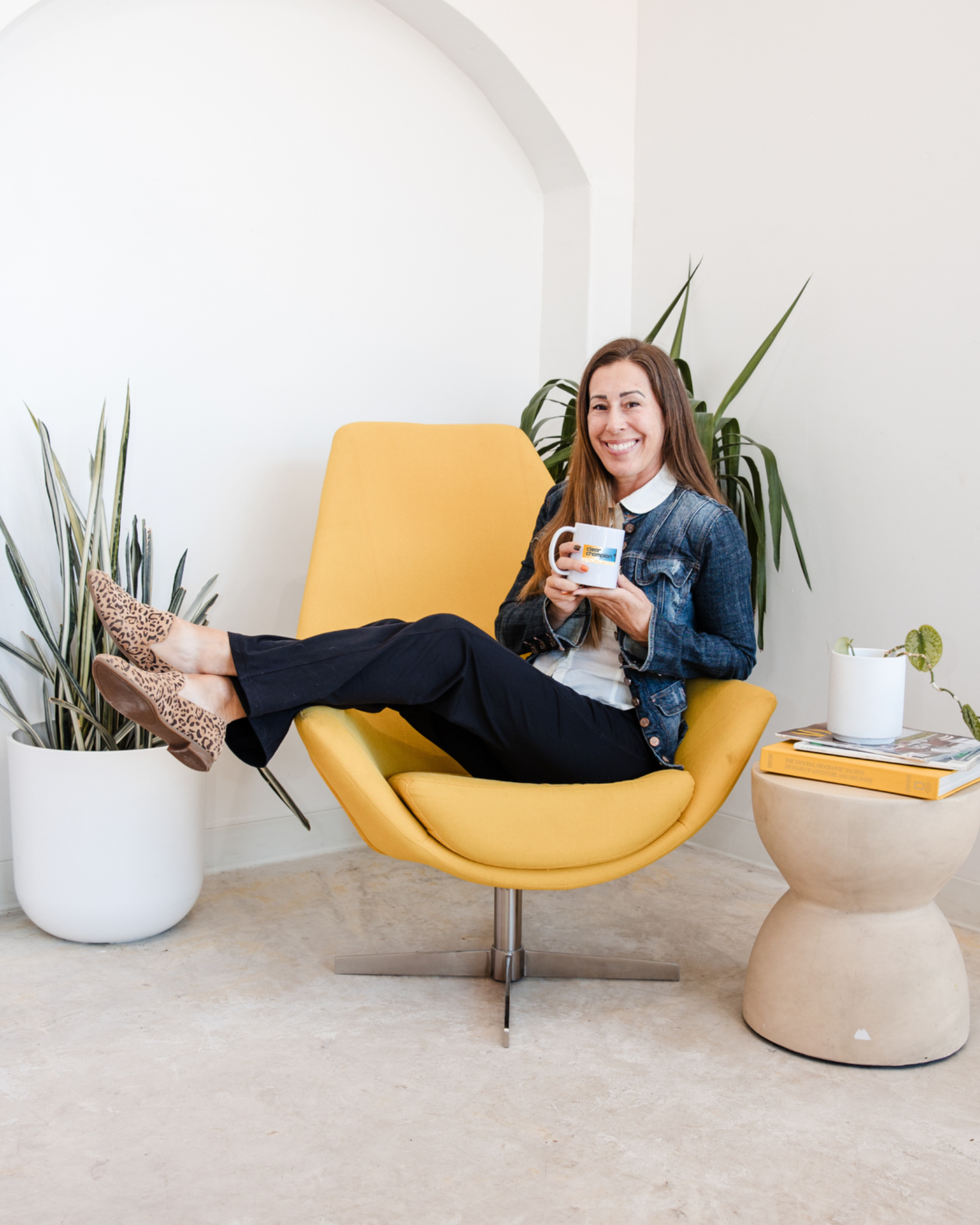 Dallas Miller, founder of Clear Champion, holding her Clear Champion mug